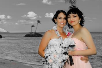 Bride and friend in black and white with color in flowers 
